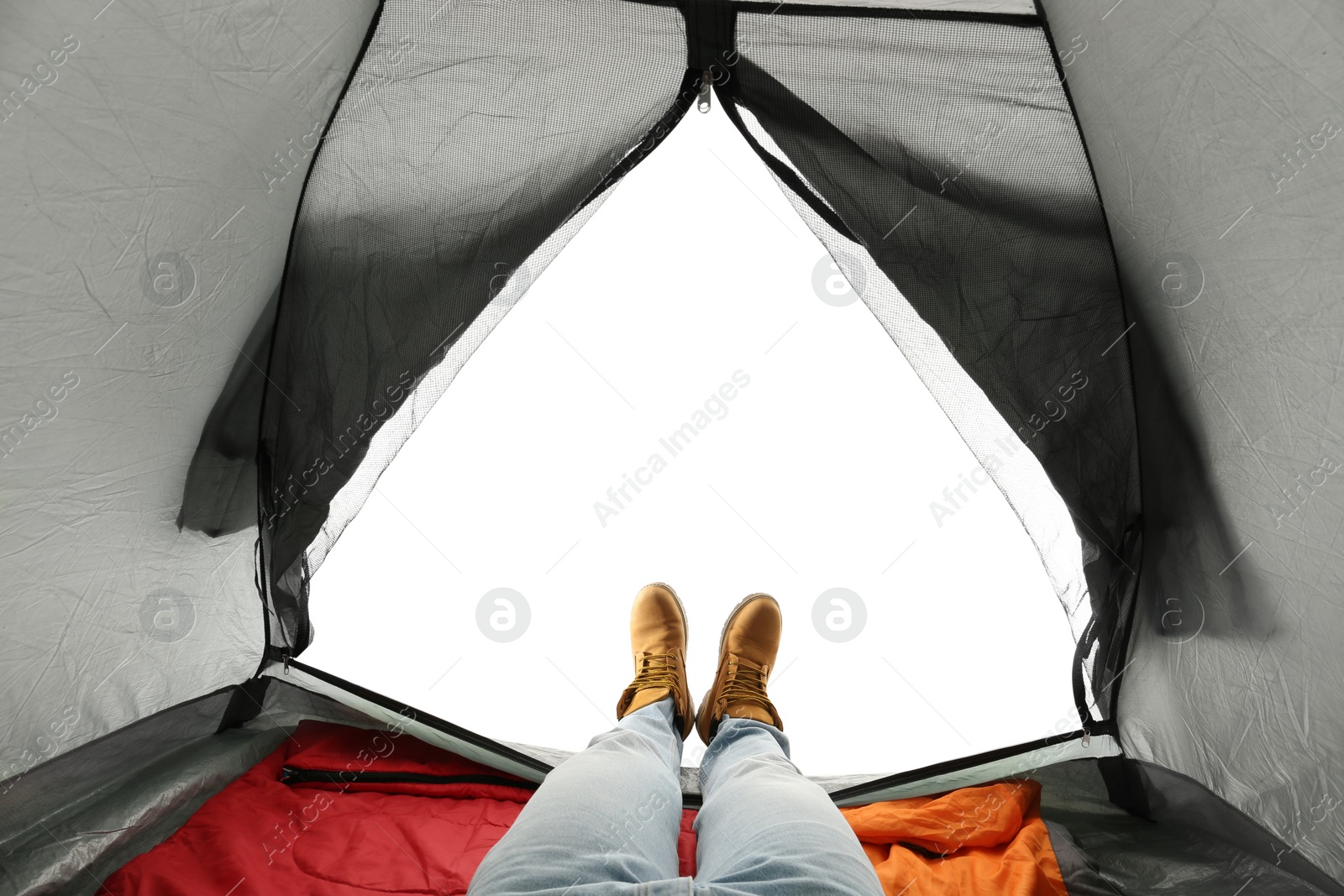 Photo of Closeup of man in camping tent on white background, view from inside