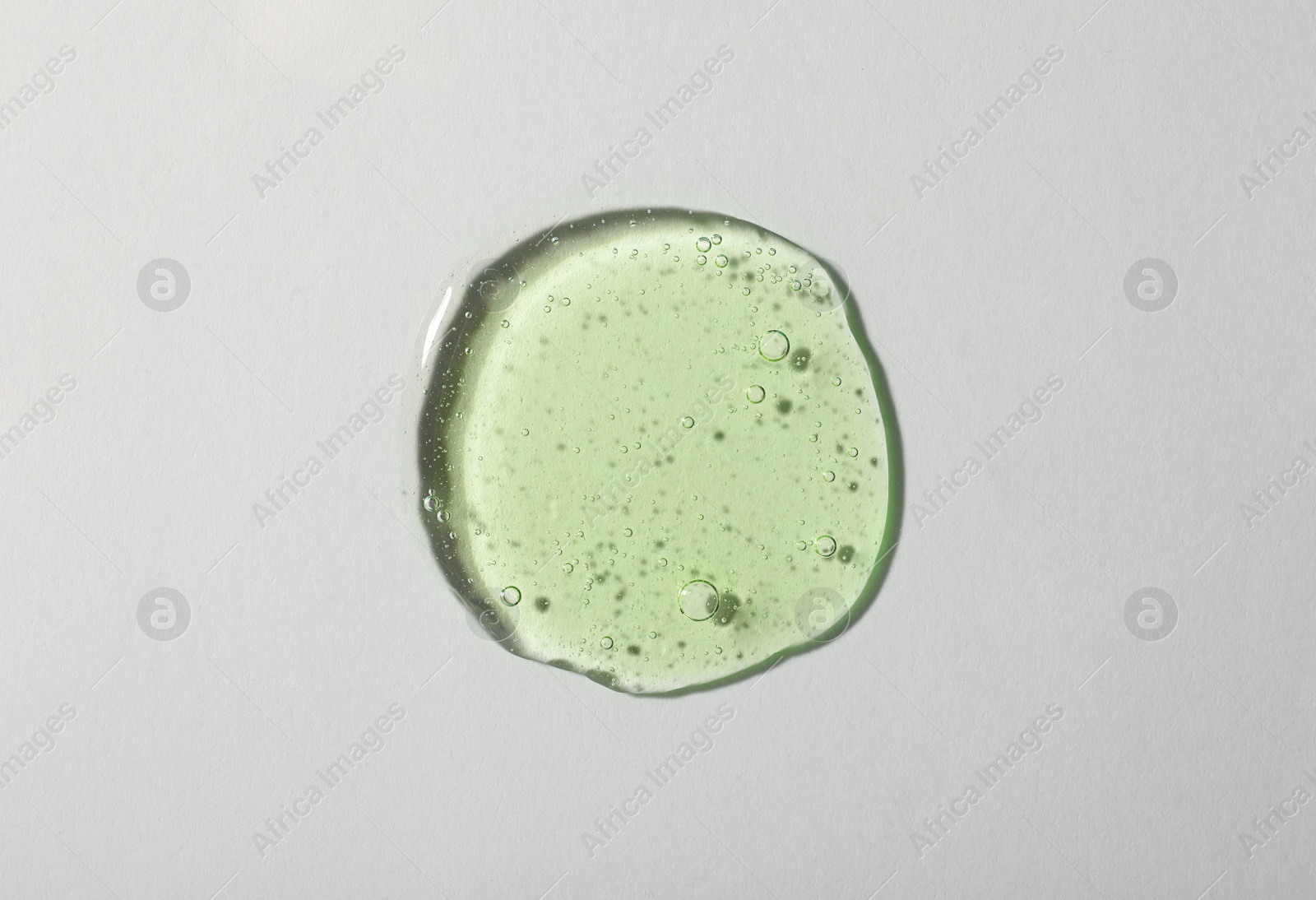 Photo of Sample of cosmetic gel on light background, top view