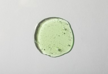 Photo of Sample of cosmetic gel on light background, top view