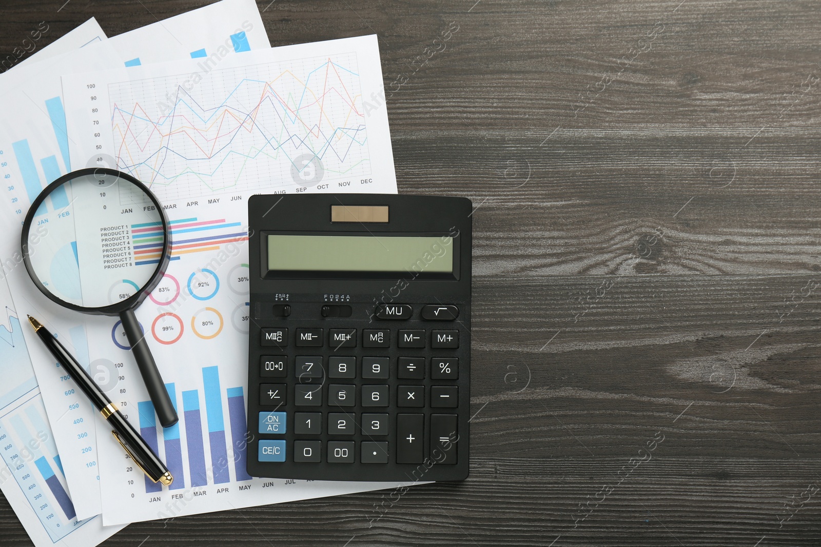 Photo of Accounting documents, magnifying glass, calculator and pen on wooden table, top view. Space for text