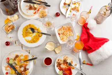 Photo of Flat lay composition of food leftovers after party on table