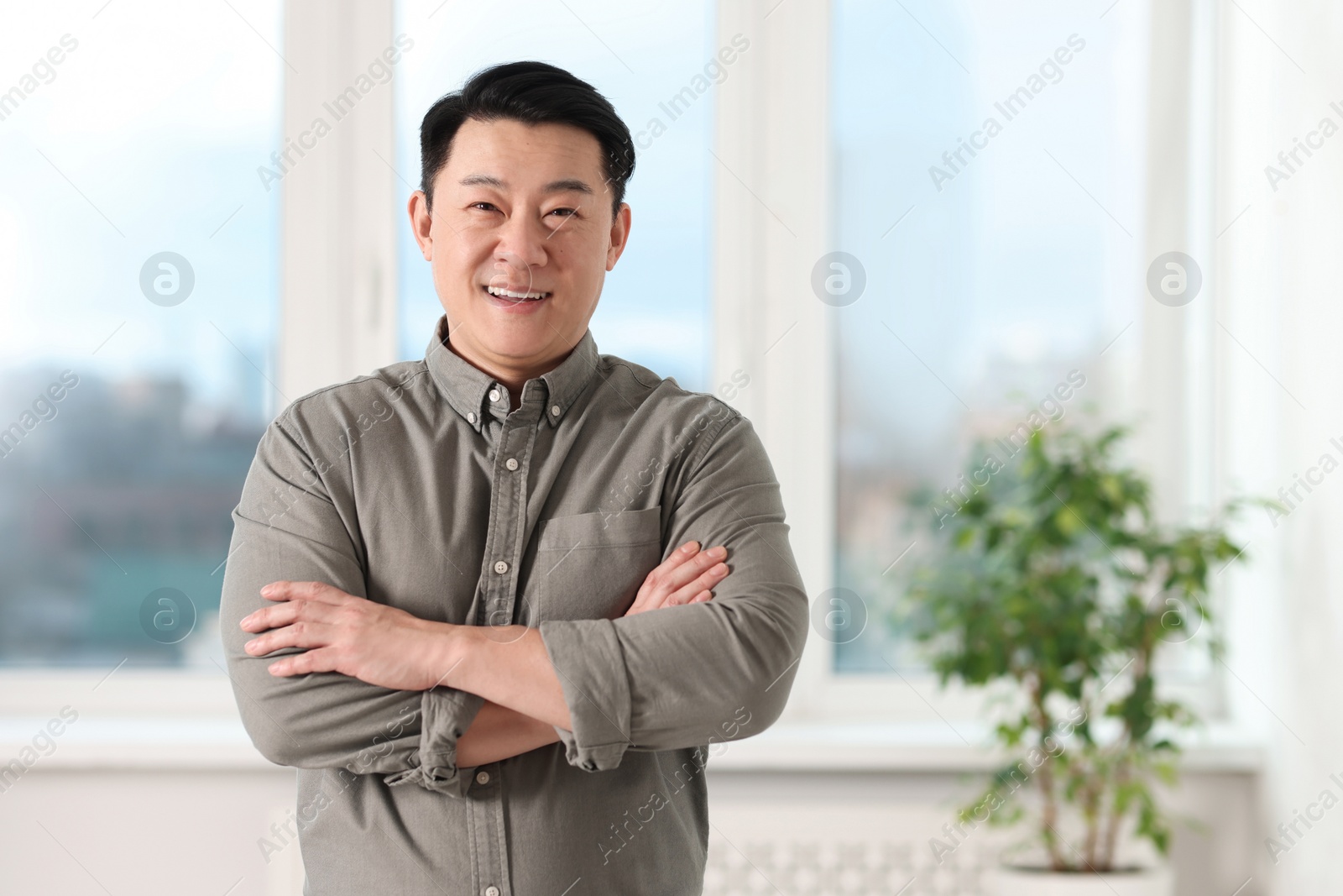 Photo of Portrait of smiling businessman in office. Space for text