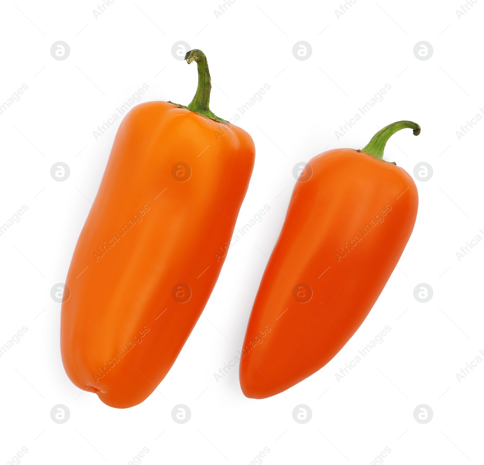 Photo of Fresh raw orange hot chili peppers isolated on white, top view