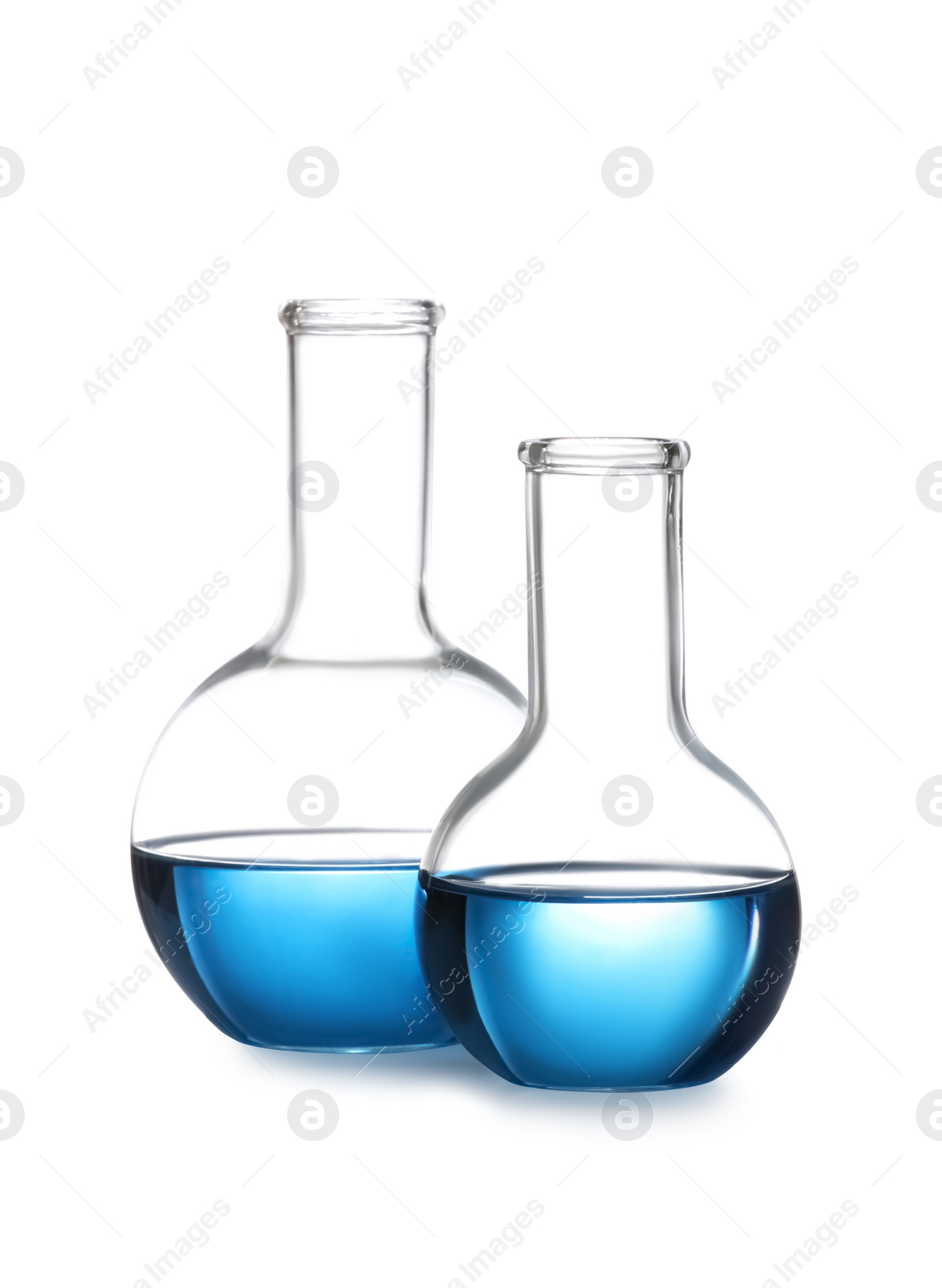 Photo of Florence flasks with blue liquid isolated on white. Laboratory glassware