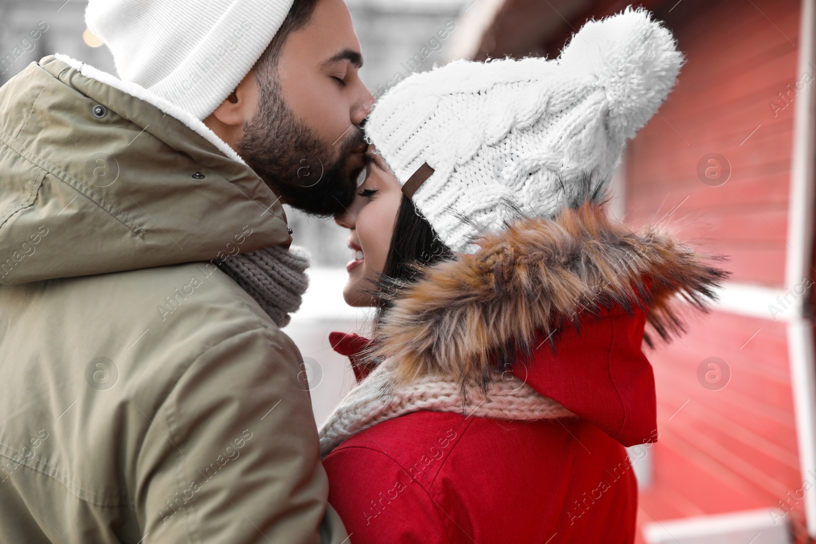 Photo of Happy young couple spending time together at winter fair. Christmas celebration