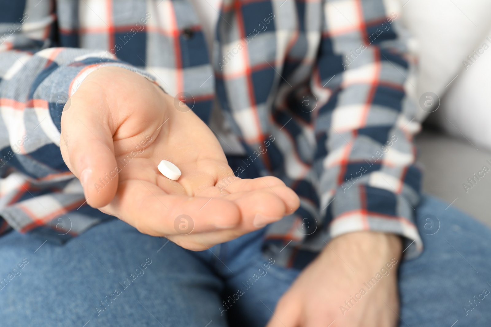 Photo of Man holding pill in hand, closeup view. Health care