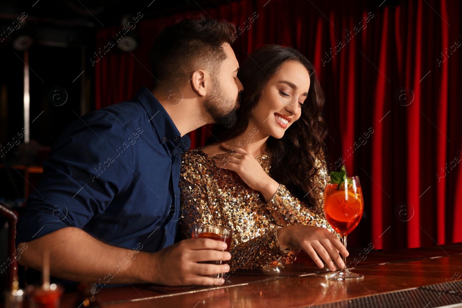 Photo of Lovely couple with fresh cocktails at bar counter