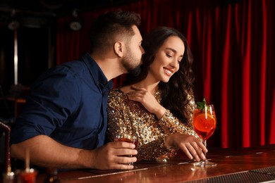 Photo of Lovely couple with fresh cocktails at bar counter