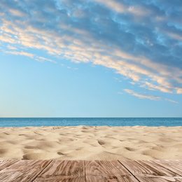 Image of Wooden surface on sandy beach near ocean