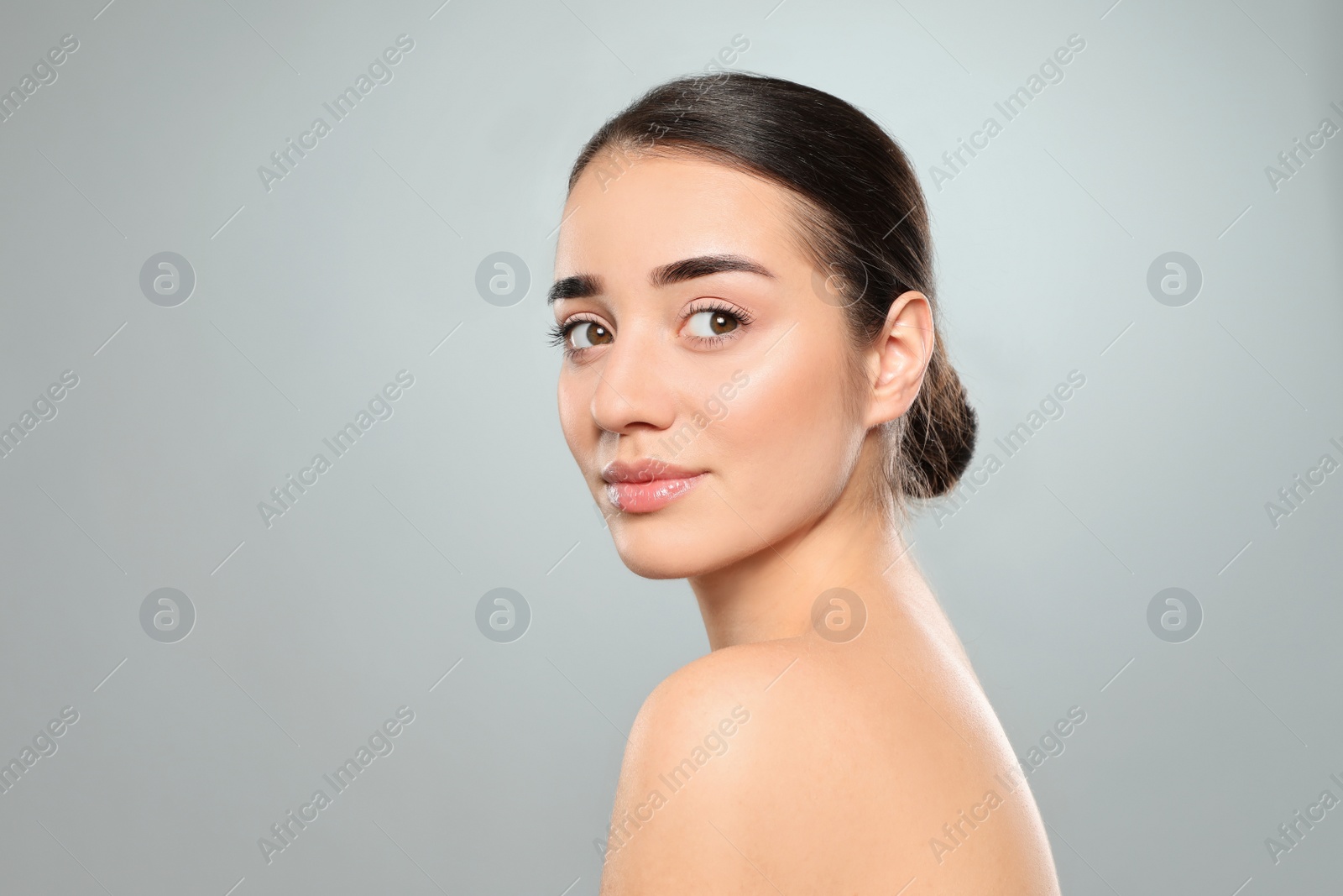 Photo of Portrait of young woman with beautiful face against color background