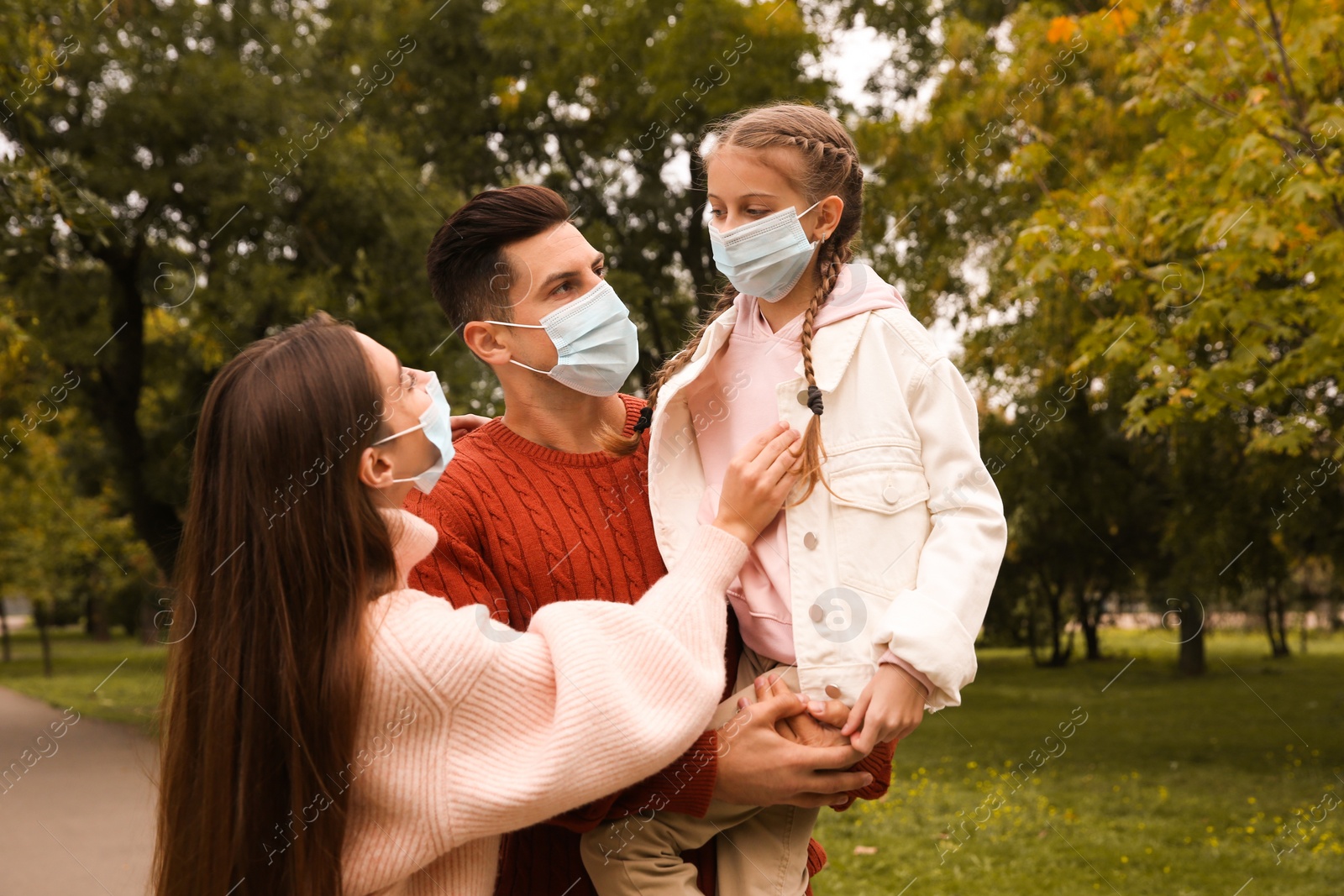 Photo of Lovely family spending time together in park during coronavirus pandemic