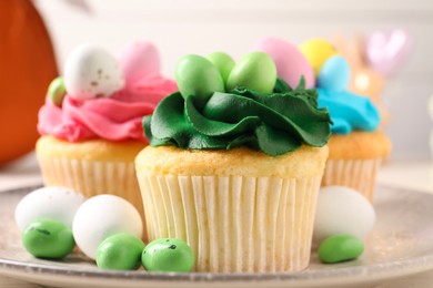 Tasty cupcakes with Easter decor on table, closeup