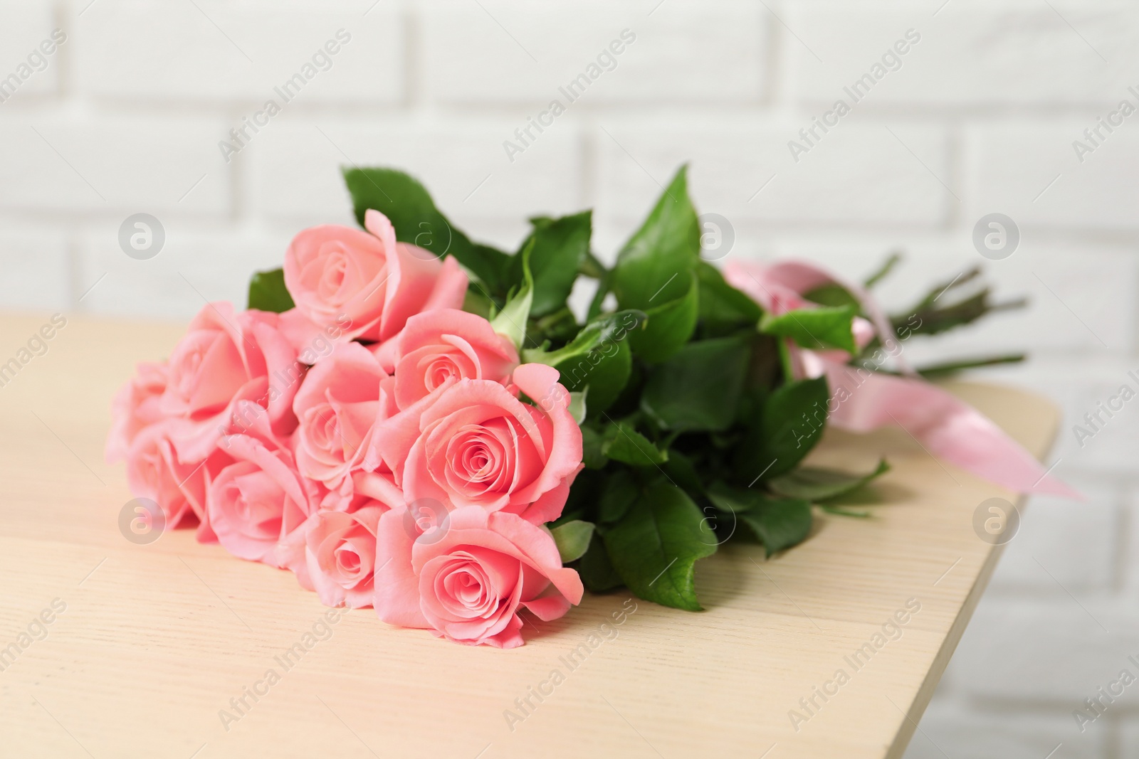 Photo of Bouquet of beautiful roses on table