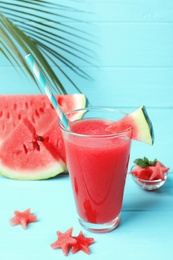 Summer watermelon drink in glass and sliced fruit on table