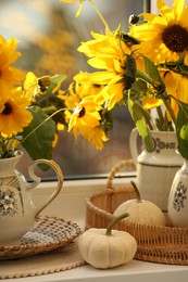 Photo of Composition with beautiful flowers and pumpkins on table. Autumn atmosphere