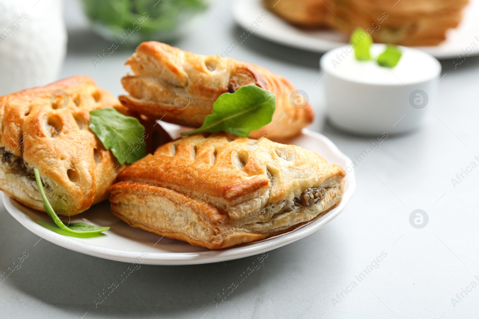 Photo of Fresh delicious puff pastry served on light table, closeup