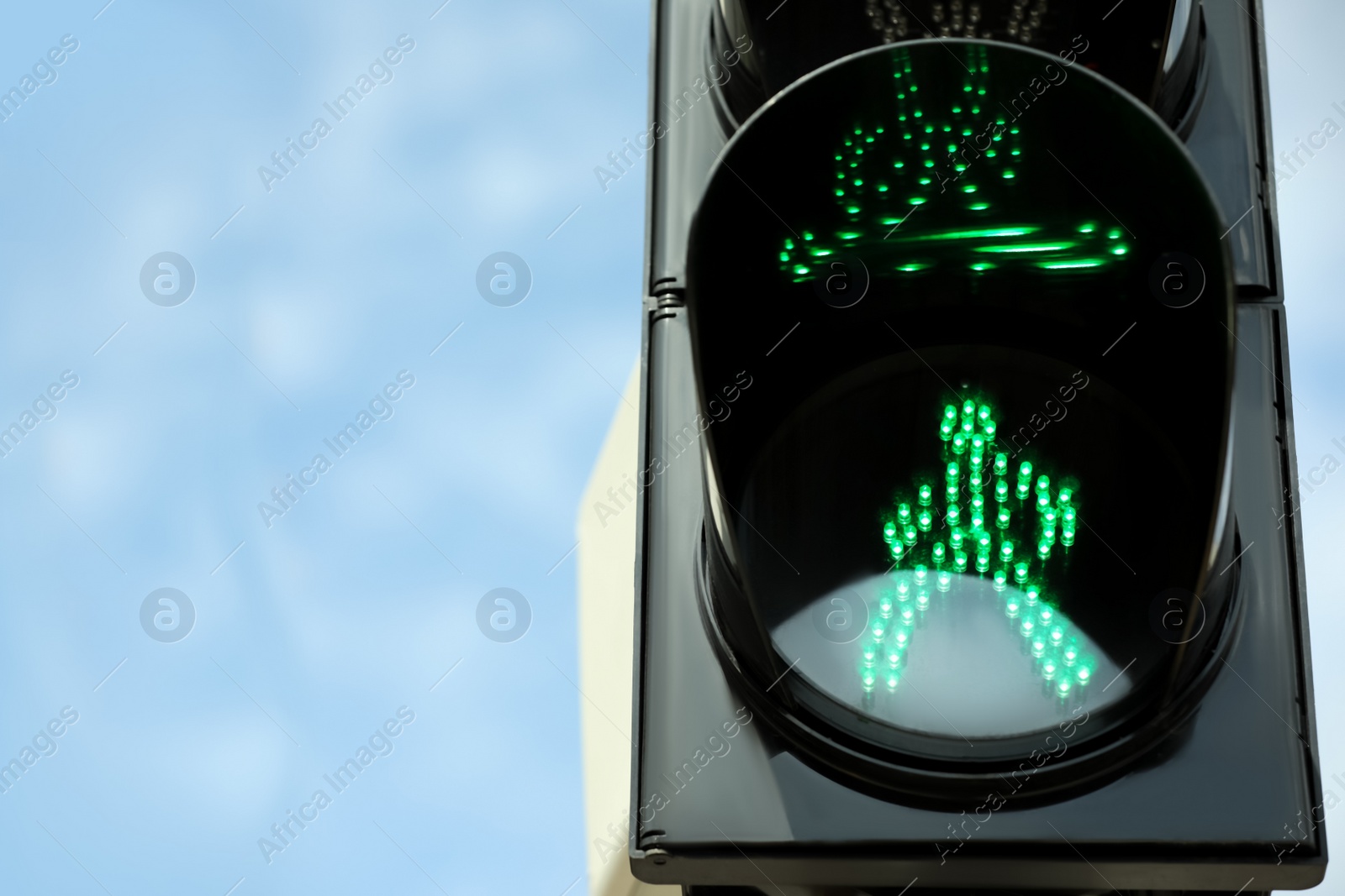 Photo of Closeup view of traffic light against blue sky. Space for text