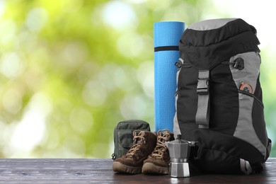 Image of Camping equipment for tourist on wooden surface outdoors