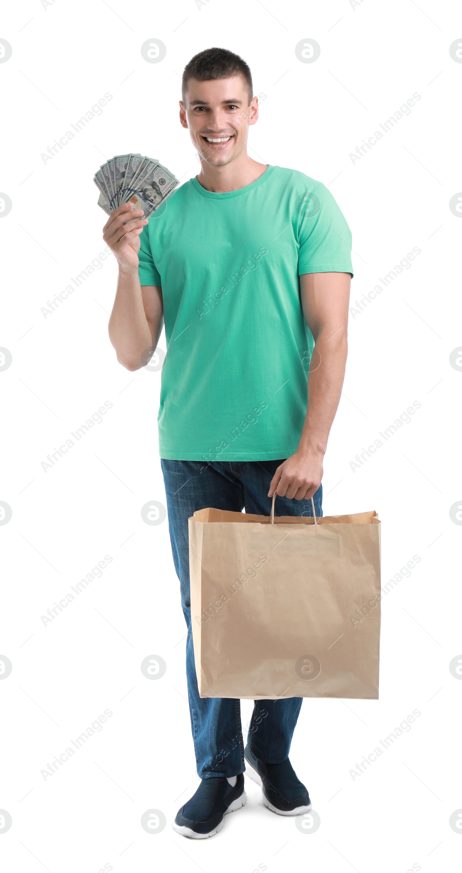 Photo of Handsome young man with dollars and shopping bag on white background