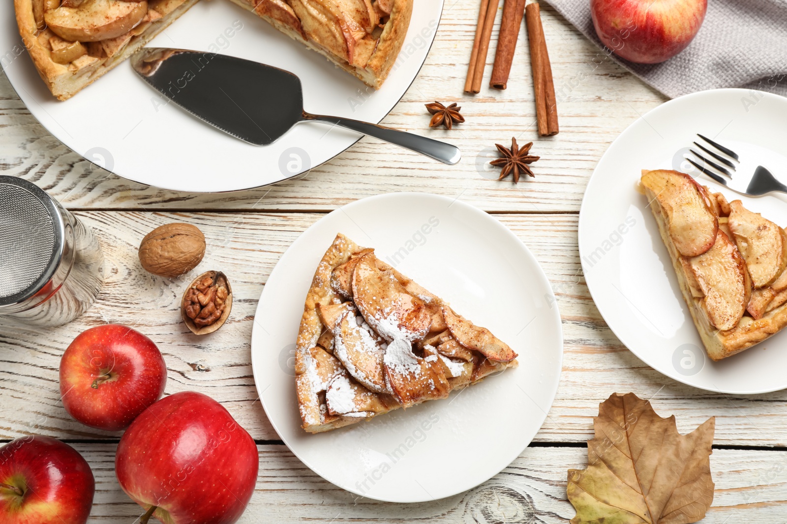Photo of Flat lay composition with delicious apple pie on white wooden table