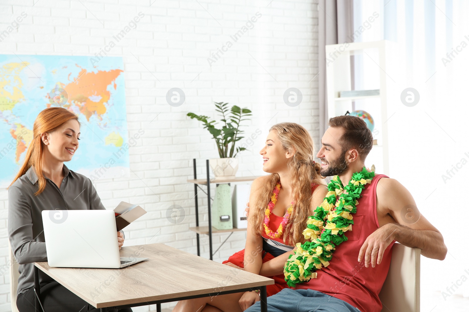 Photo of Beautiful young couple visiting travel agency office