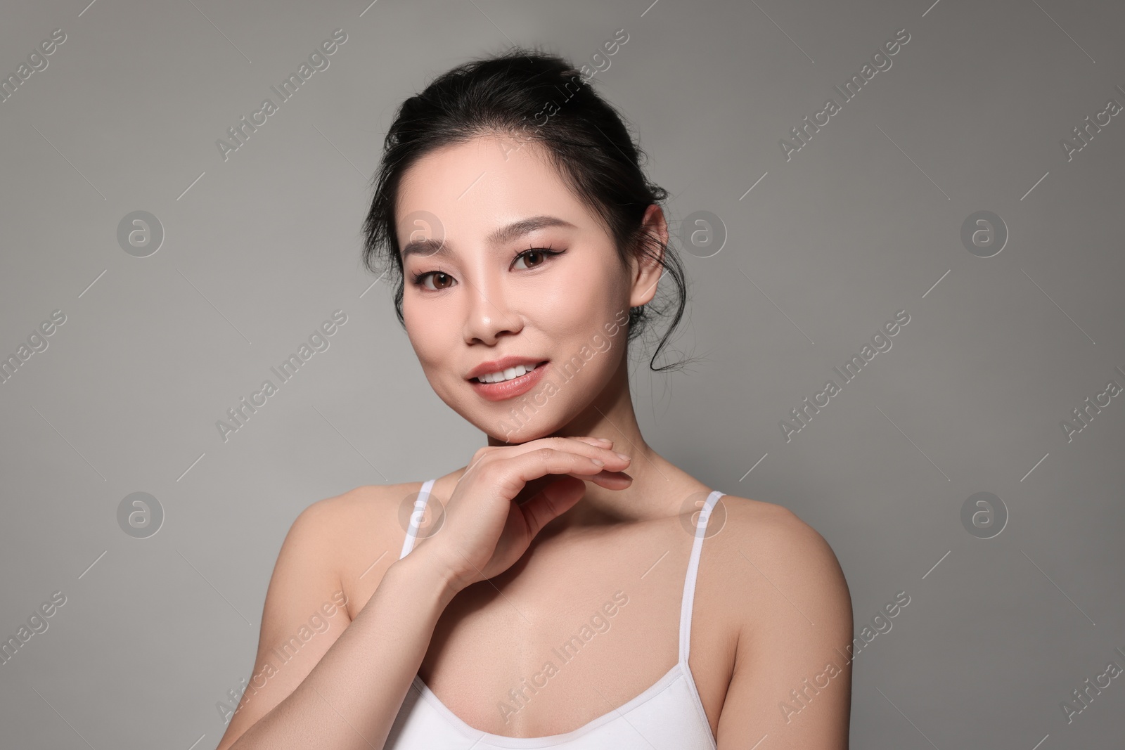 Photo of Portrait of beautiful woman on grey background