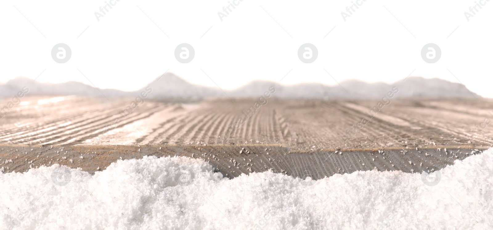 Photo of Heap of snow near wooden surface isolated on white