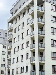 Photo of Exterior of beautiful residential building with balconies on city street