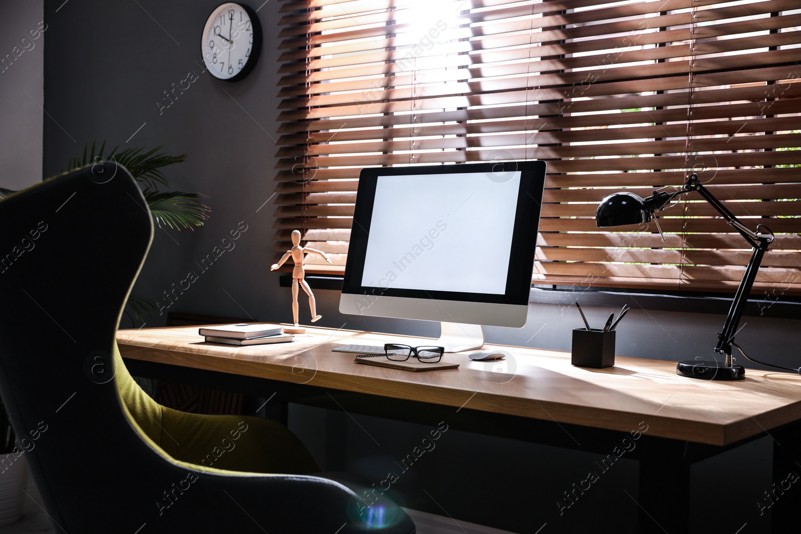 Photo of Stylish room interior with modern computer and comfortable office chair