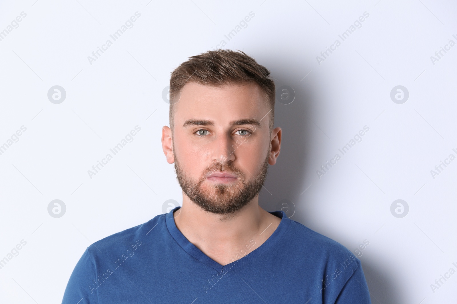Photo of Portrait of handsome serious man on white background