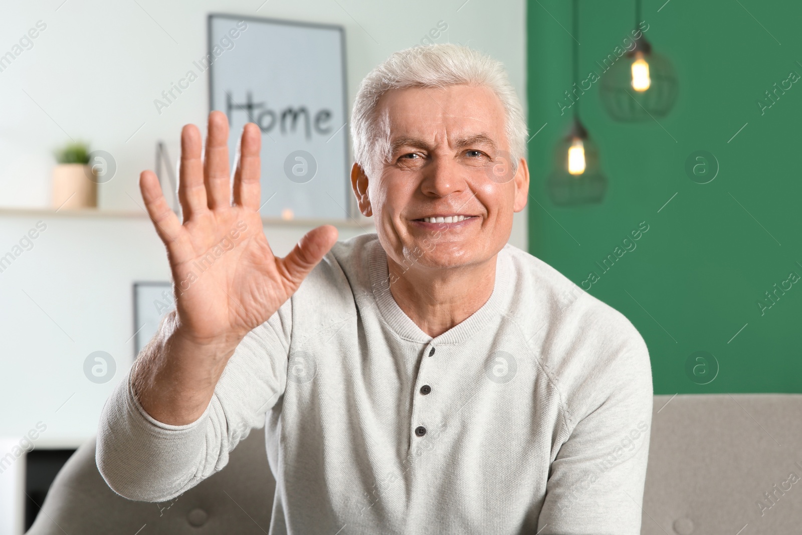 Photo of Mature man using video chat at home, view from web camera