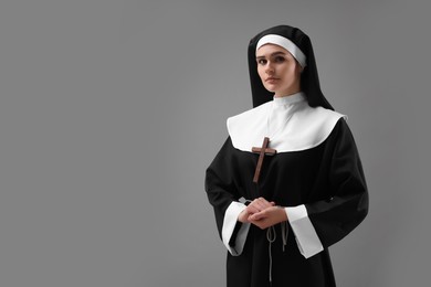 Photo of Nun on grey background, space for text