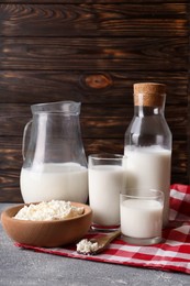 Tasty fresh milk and cottage cheese on grey table