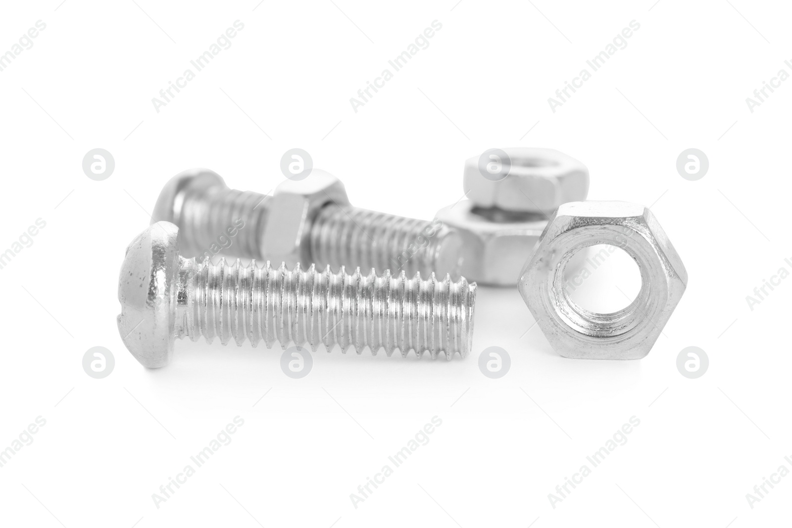 Photo of Metal bolts and hex nuts on white background