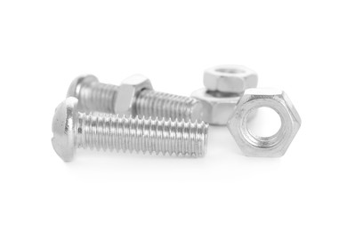 Metal bolts and hex nuts on white background