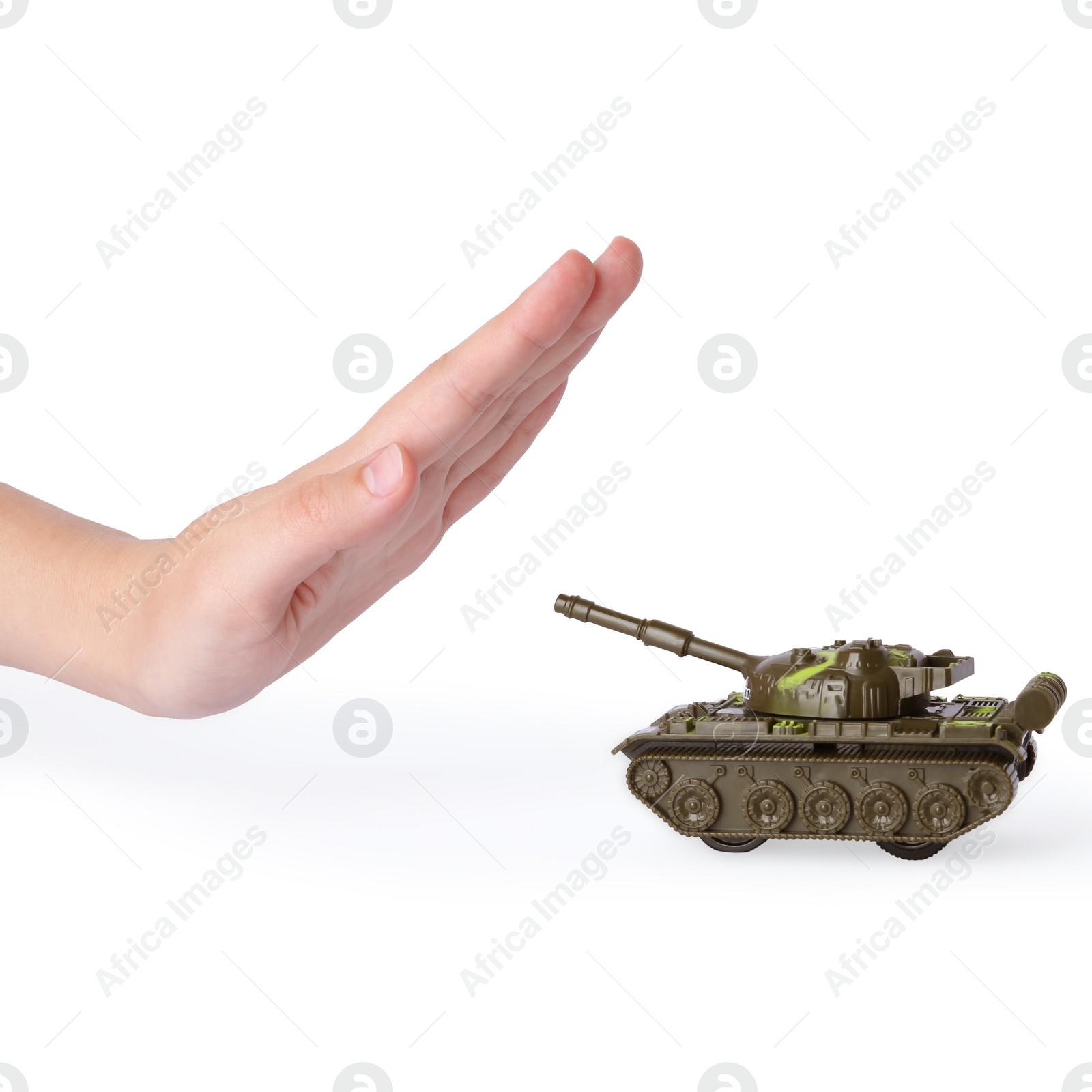 Photo of Woman showing stopping sign in front of toy tank on white background. No war concept