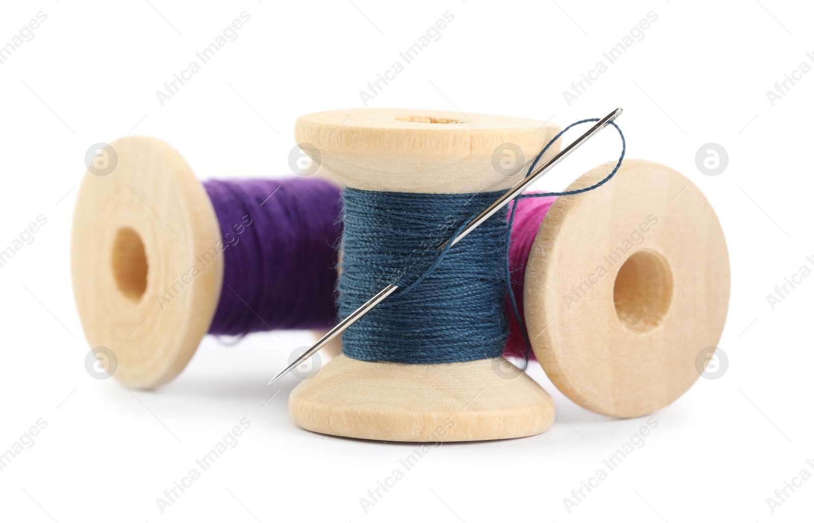 Photo of Different colorful sewing threads with needle on white background