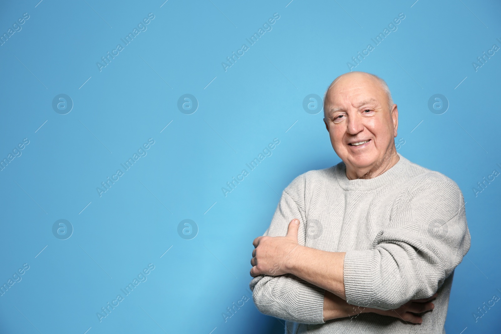 Photo of Portrait of elderly man on color background. Space for text