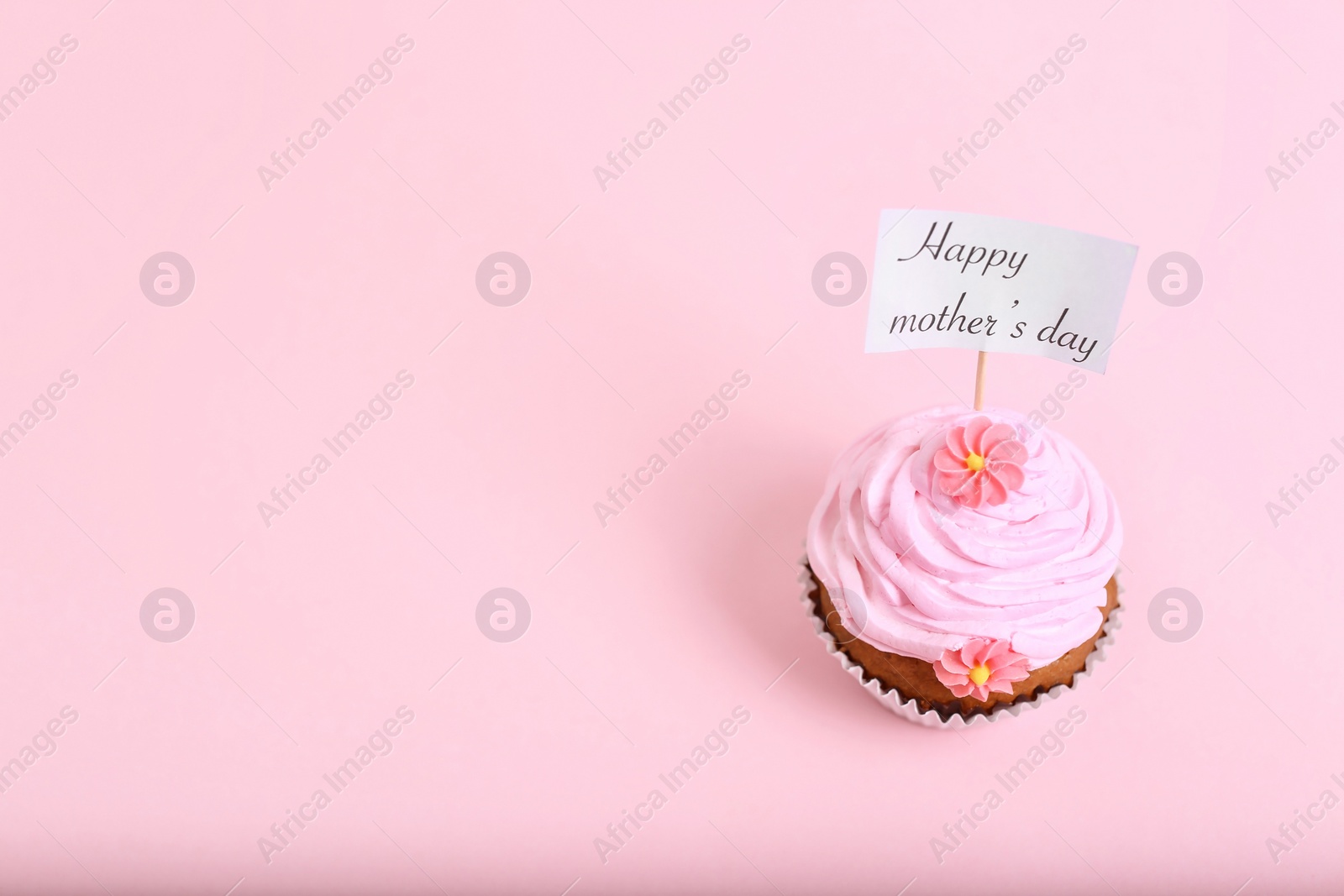 Photo of Topper with words HAPPY MOTHER'S DAY in cupcake on color background