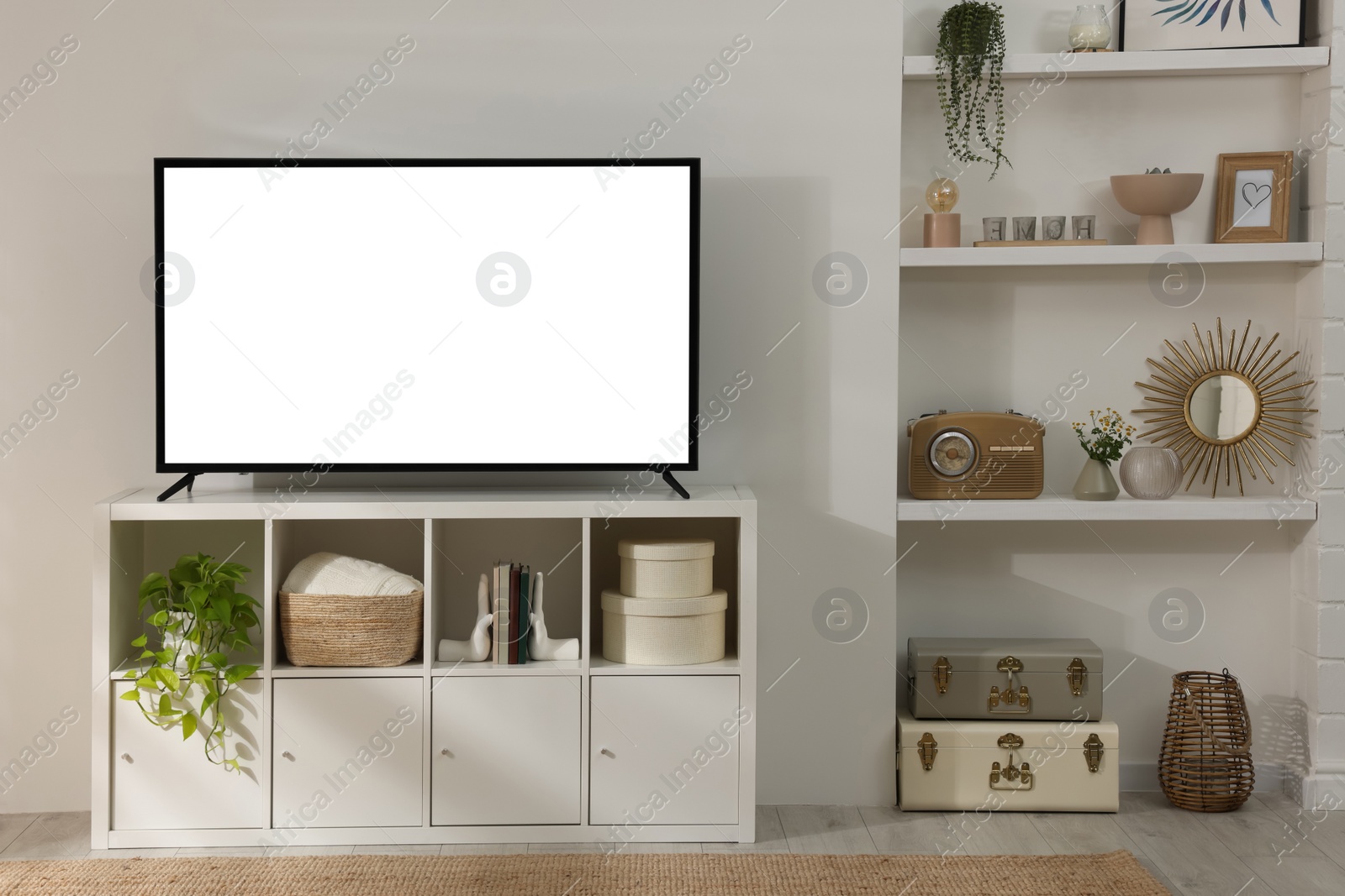 Image of Modern TV set on stand in room