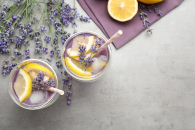 Photo of Fresh delicious lemonade with lavender on grey table, flat lay. Space for text
