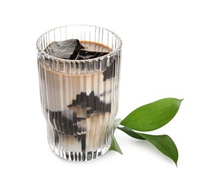 Photo of Glass of milk with grass jelly and green leaves on white background