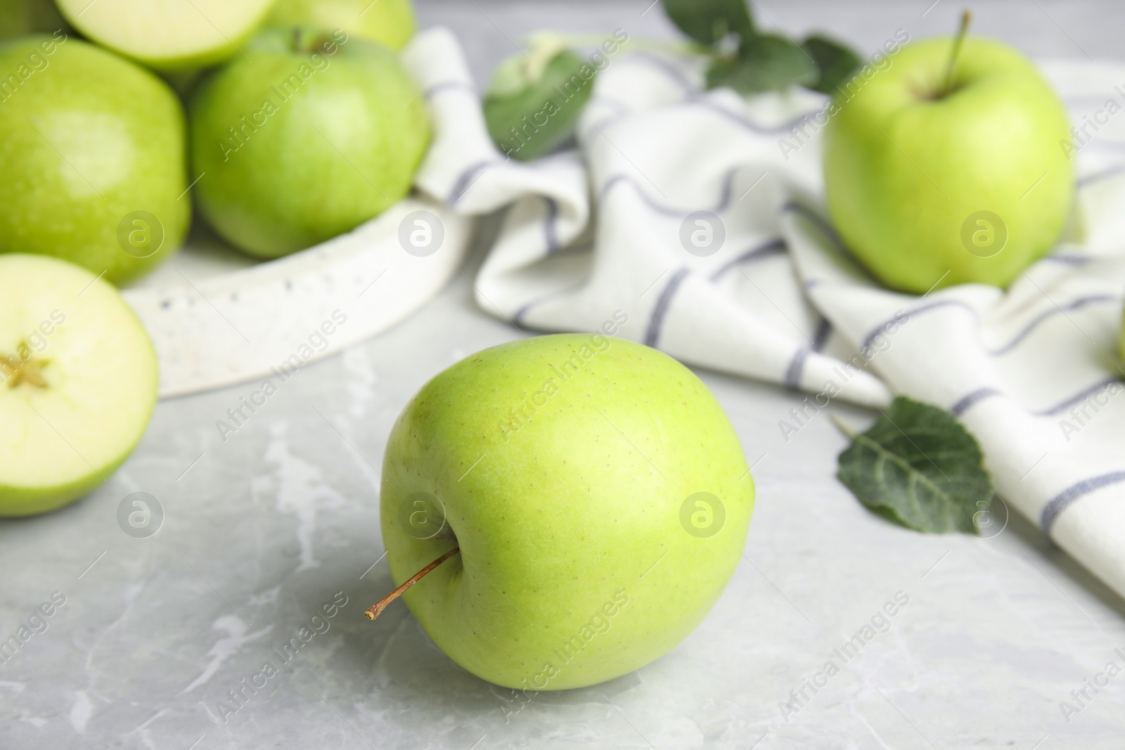 Photo of Fresh ripe green apples on grey stone table, space for text