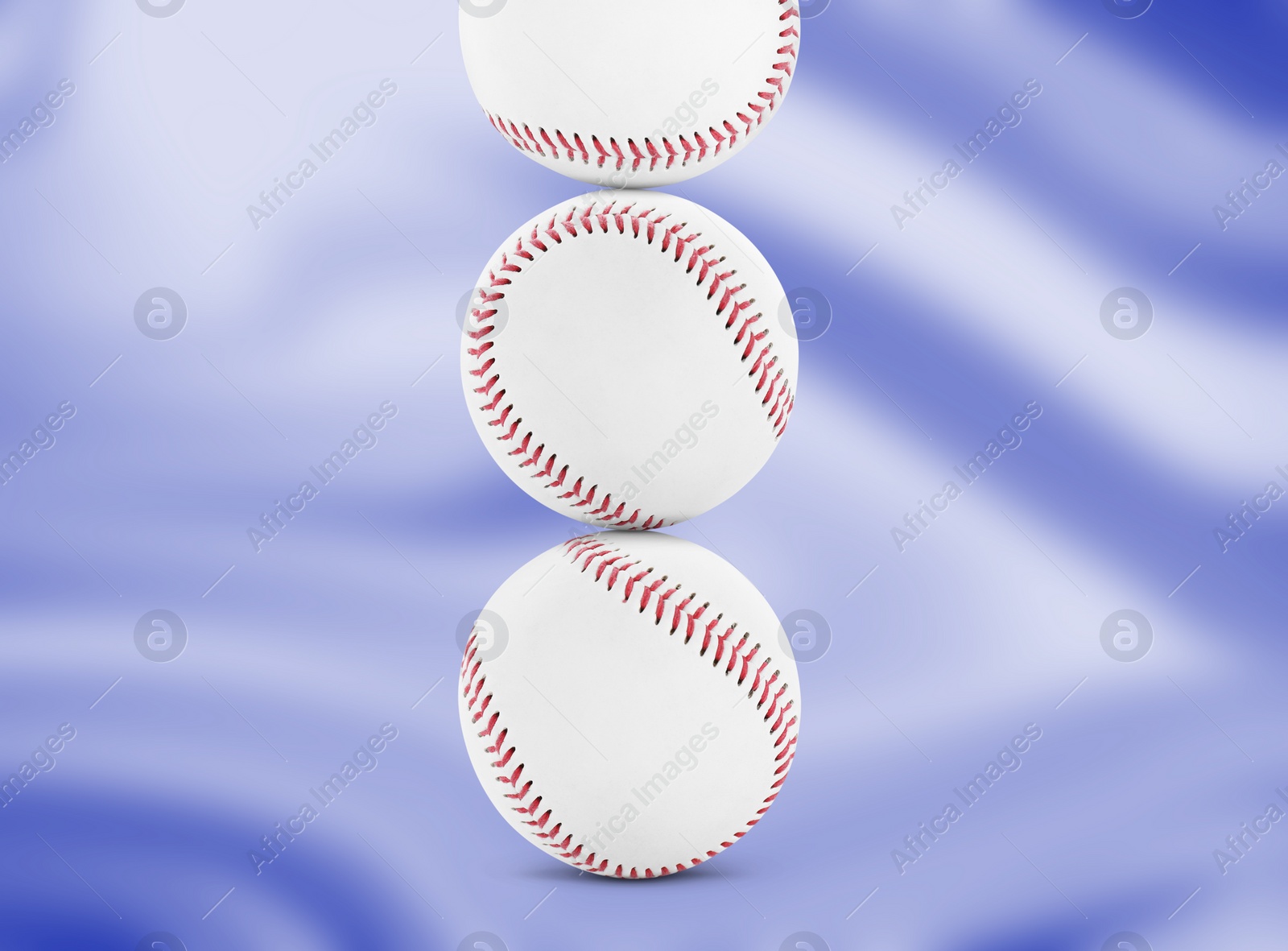 Image of Stack of baseball balls on blue background