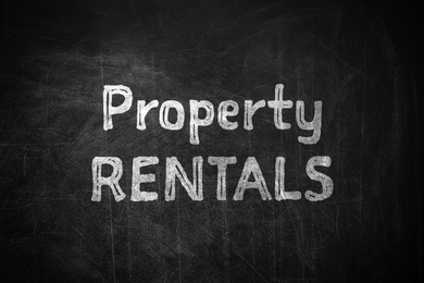 Image of Text Property Rentals written on black chalkboard