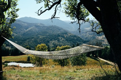 Empty comfortable net hammock in mountains on sunny day