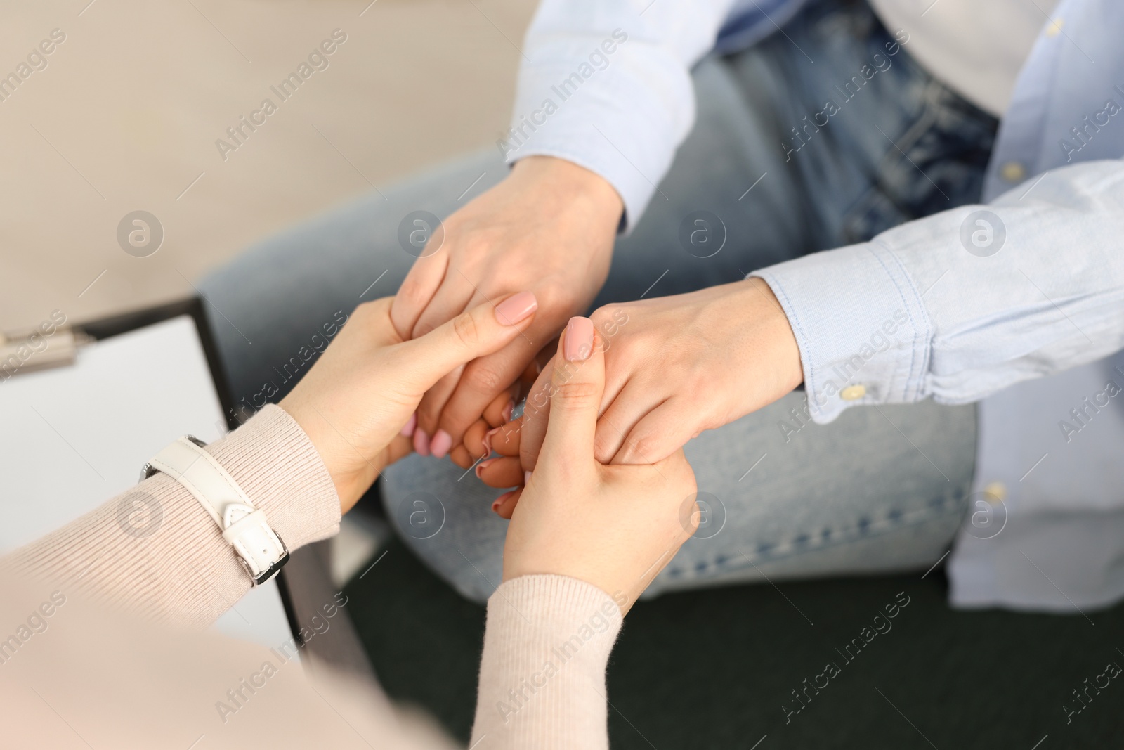 Photo of Psychotherapist working with patient in office, closeup