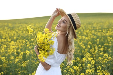 Portrait of happy young woman in field on spring day