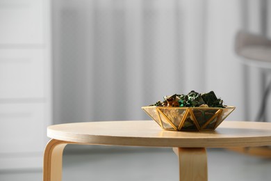 Decorative bowl with aromatic potpourri on wooden table in room, space for text