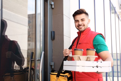 Portrait of courier with order at door. Food delivery service